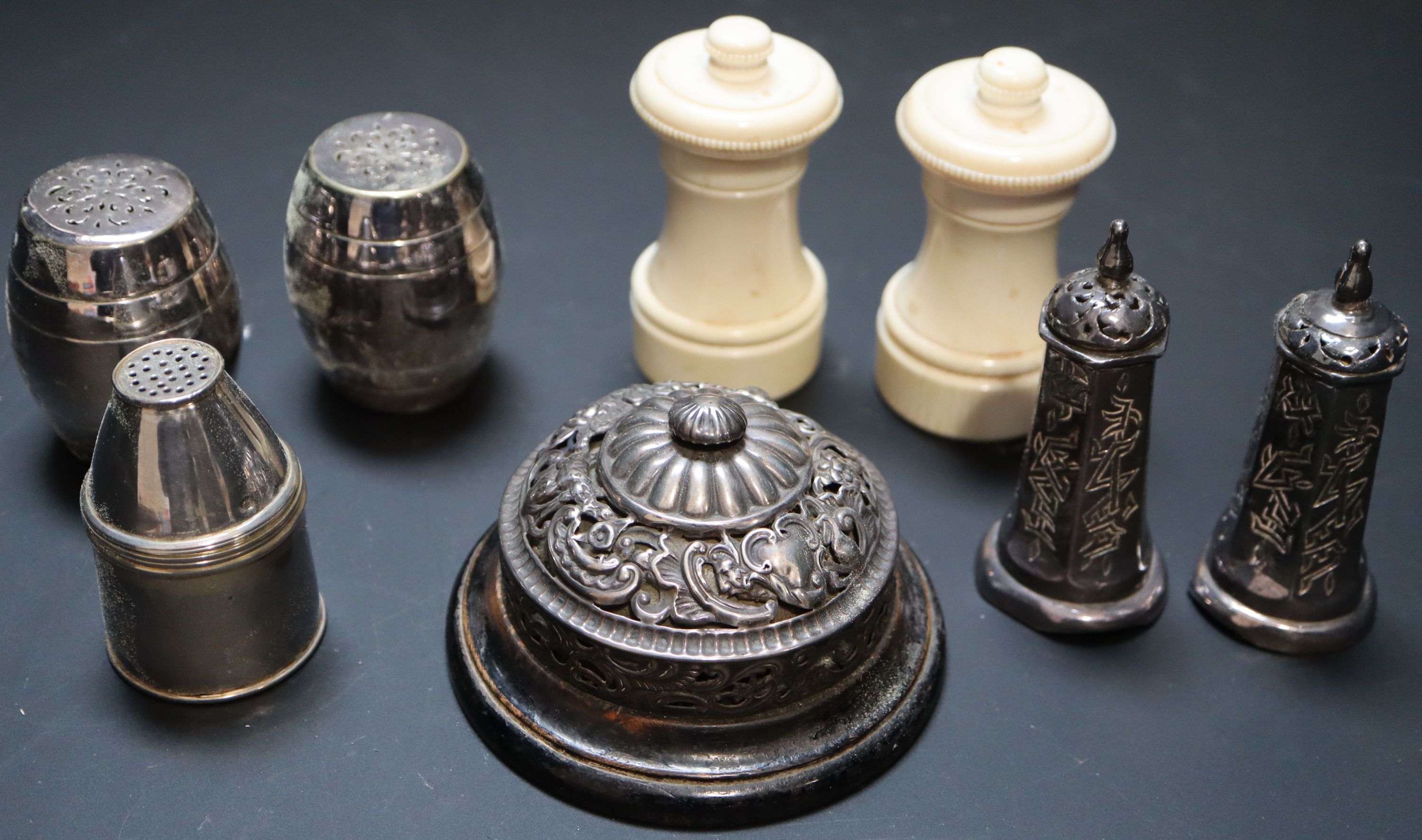 A group of condiments including Chinese and ivory and a table bell